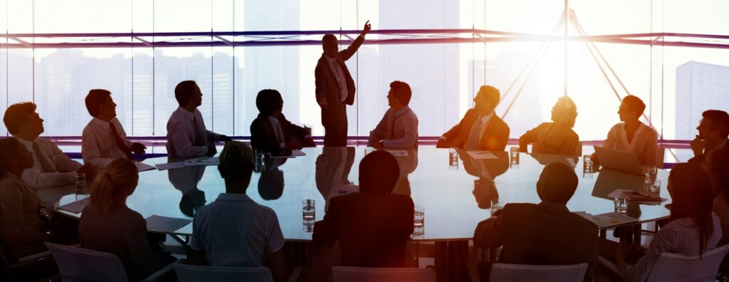 Business meeting in a modern conference room with city skyline view.